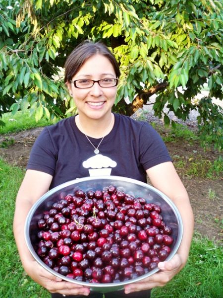 Woman holding a bowl of cherries