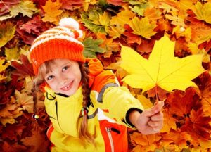 Child with autumn leaf