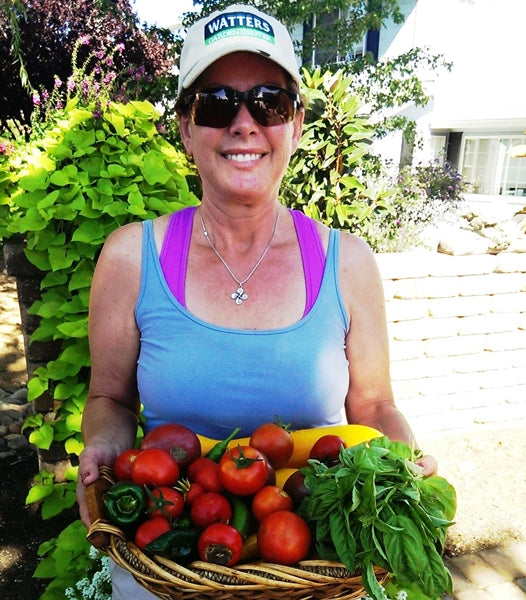 Woman Holding a Basket of Fresh picked vegetables