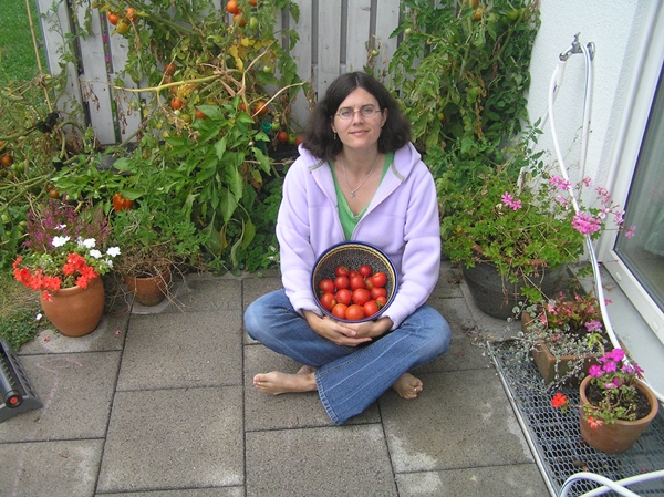 Cindy with fresh picked tomatoes from her container garden
