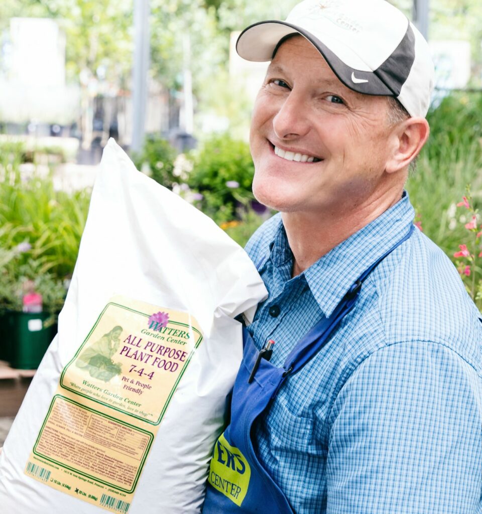 Ken holding All Purpose Plant food