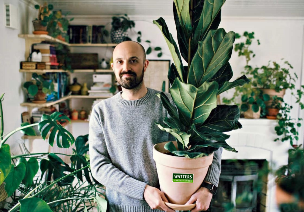 Guy Holding a houseplant
