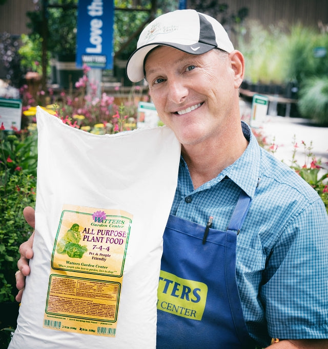 Ken Lain holding plant food